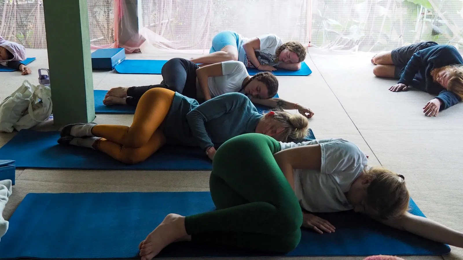 People practicing meditation and relaxation in a yoga class in Chiang Mai, Thailand.